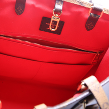 Load image into Gallery viewer, Roomy interior of the LV ONTHEGO MM Tote with multiple pockets
