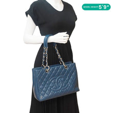 Load image into Gallery viewer, CHANEL Grand Shopping Blue Quilted Leather Tote Bag - Model Holding
