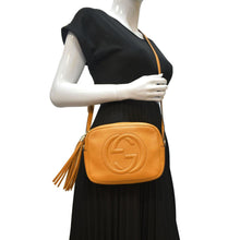 Load image into Gallery viewer, GUCCI Soho Disco Elegance: Leather Crossbody Bag Orange with body view
