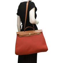 Load image into Gallery viewer, HERMES HerbagTote Shoulder Bag Canvas/Leather Red/brown with body view
